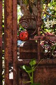 Rusty metal fence with ladybird ornament