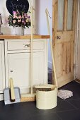 Cleaning utensils in front of country house style kitchen unit