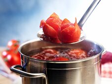 Tomatoes being blanched in boiling water