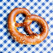 A pretzel on a blue and white tablecloth