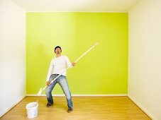 Man rocking while painting a room