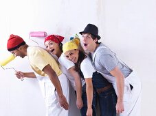 Group of friends about to paint wall.