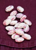 Borlotti beans on a purple table cloth