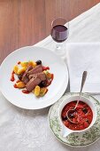 Beef steak with tomato and olive sauce and gnocchi