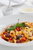 Tagliatelle with sardines, giant capers and tomato wedges