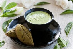 Matcha tea in a tea bowl, served with tea-flavoured madeleines