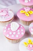 Cupcakes with pink and white glaze and sugar roses