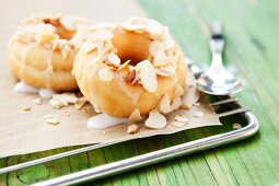 Doughnuts with icing sugar and slivered almonds