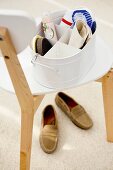 Shoe shining set on a chair, underneath a pair of shoes