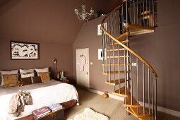 Spiral staircase in a roomy bedroom with brown walls