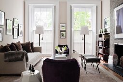 Pair of Dennis Miller Madame X Benches in living room with Robert Kuo white faceted coffee table