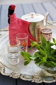 Mint leaves and tea glasses with teapot, Marrakesh