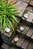 Simple brick staircase decorated with rustic lanterns and ornamental grass