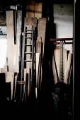 Dark store room with wooden boards leaning on wall