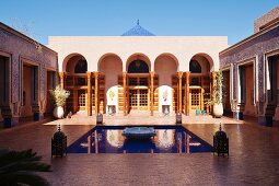 Water feature and lanterns in courtyard of modern moroccan house