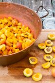Apricots being prepared for stewing: pitting and quartering
