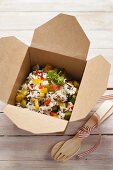 Rice with vegetables in a takeaway box
