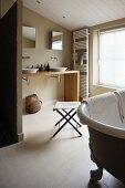 Freestanding vintage bath tub in a modern bathroom