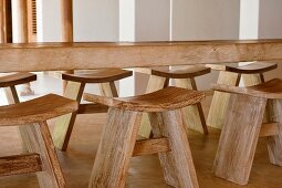 Carved wooden table and stools in beach house retreat, Indian state of Goa