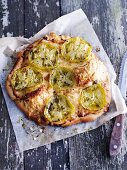 Pizza topped with green tomatoes