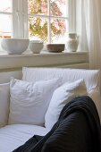 Cozy window area with white upholstered armchair and pillows