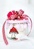 Screw top jar decorated with a hand painted toadstool