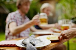 Friends enjoying a barbeque in the garden