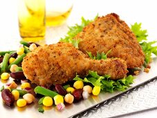 Breaded chicken legs with sweetcorn and beans