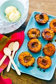 Barbecued peach halves with vanilla ice cream