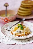 Apple and raisin pancakes topped with custard