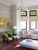 Lounge area with upholstered seating and coffee table in traditional setting with bay window