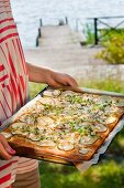 Pizza with pears and feta cheese on a baking tray (Sweden)