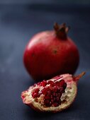 A whole pomegranate and a wedge