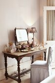 Nostalgic dressing table with mirror on top and various perfume bottles