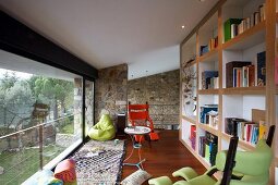 Peaceful library with glass wall and open view of garden