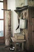 Wooden stool, cleaning utensils & tools in rustic interior