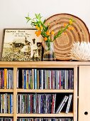 Bouquet on modern cabinet with integrated CD shelves