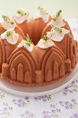 An orange sponge cake made using a cathedral baking tin