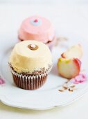 Cupcakes decorated with pastel-coloured butter cream