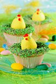 Easter cupcakes decorated with Easter eggs and green sprinkles