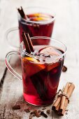 Two glasses of mulled wine with cinnamon, oranges and cloves