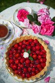 Strawberry tart and tea on a table in the garden