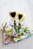 White chocolate and jam hearts in glass surrounded by small spring wreath