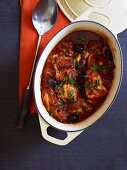 Chicken cacciatore with olives in baking dish