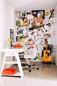 Many photographs on pinboard in small office