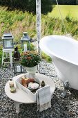 Tray of toiletries on low side table next to open-air bathtub