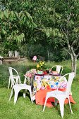 Table set with summery tablecloth in garden