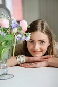 Young woman and vase of flowers