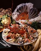 A platter of seafood with a mixture of crustaceans, oysters and vegetables