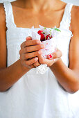 Woman holding cupcake with berries